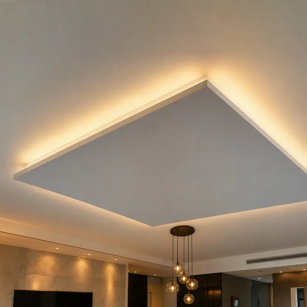 Floating gypsum island ceiling panel with a concealed shadow gap and warm uplighting